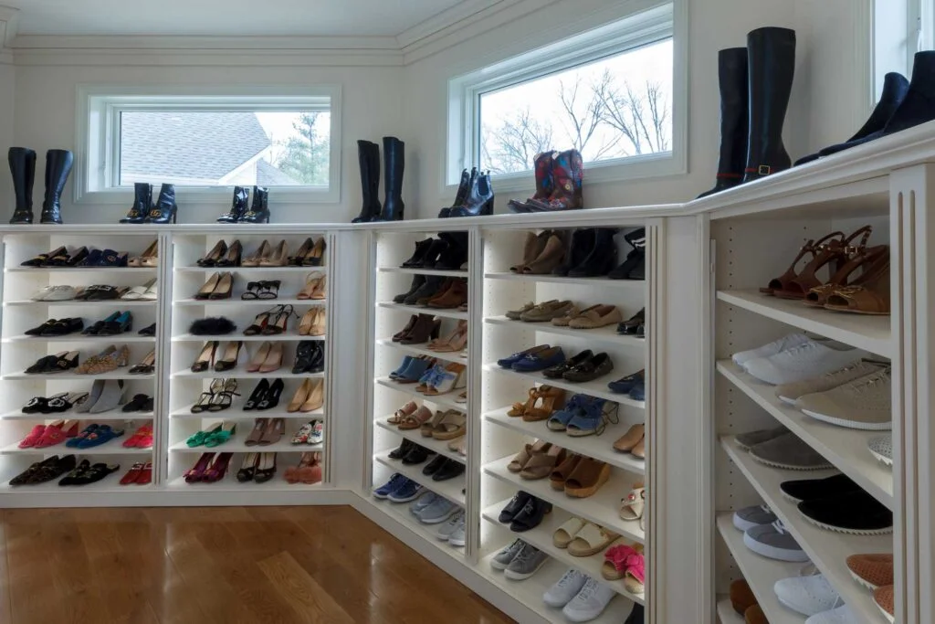 Large walk-in closet with walls of shoe storage