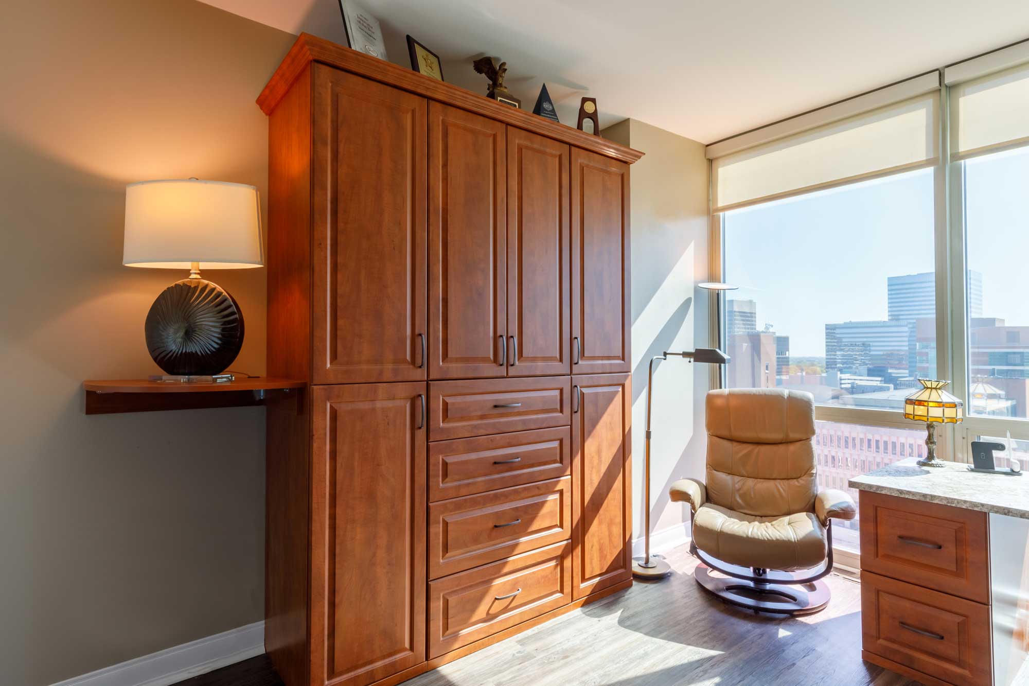 Wall bed with brown custom cabinetry