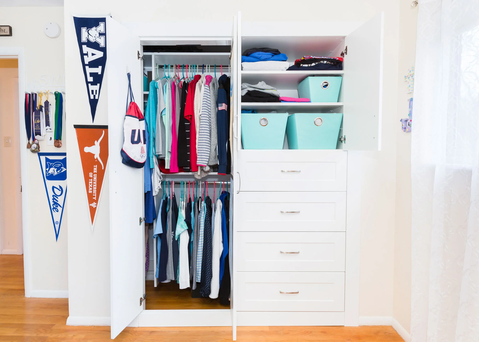 Bedroom with a reach-in closet with white cabinetry