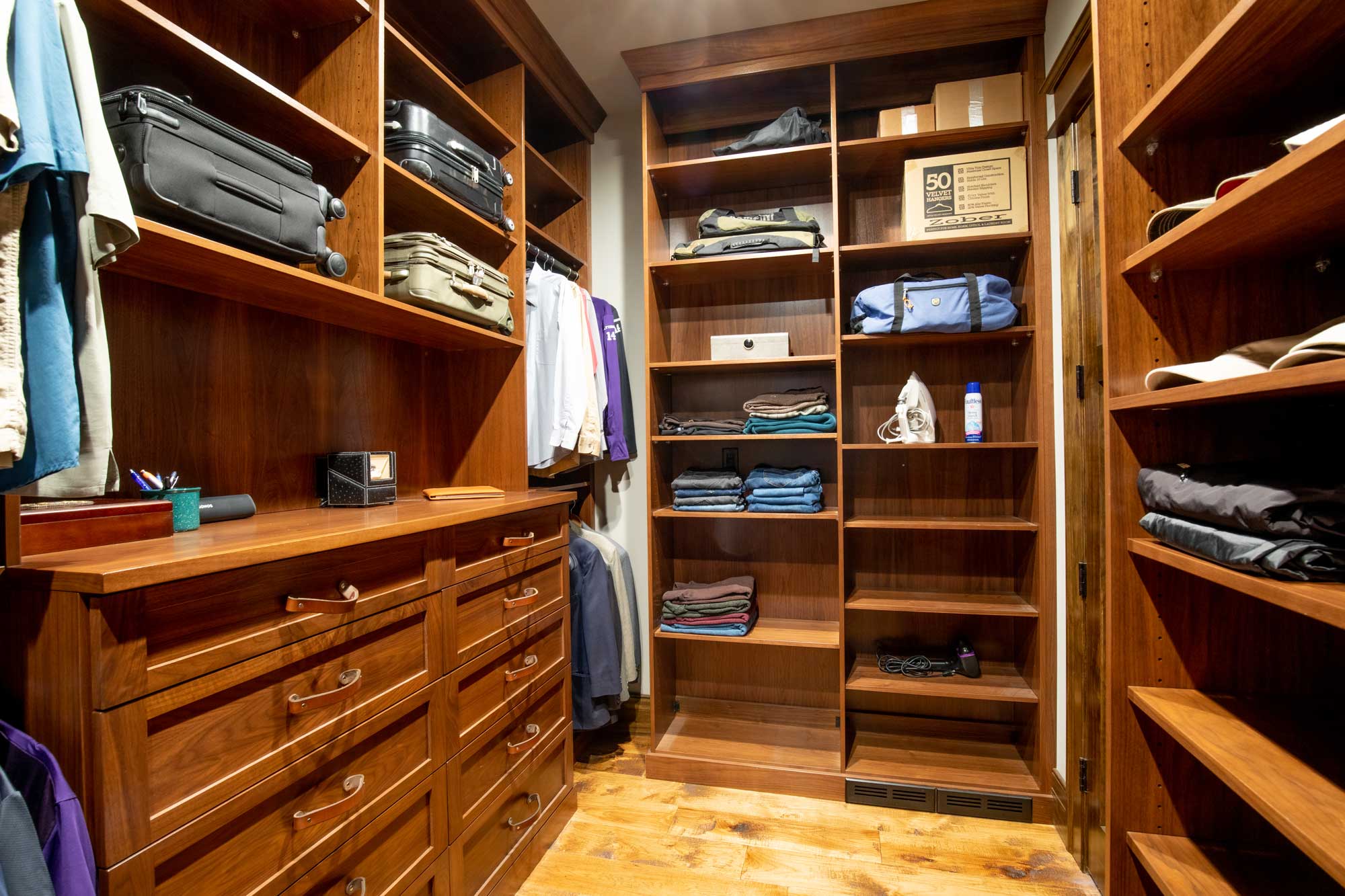 Walk-in closet with men's clothing